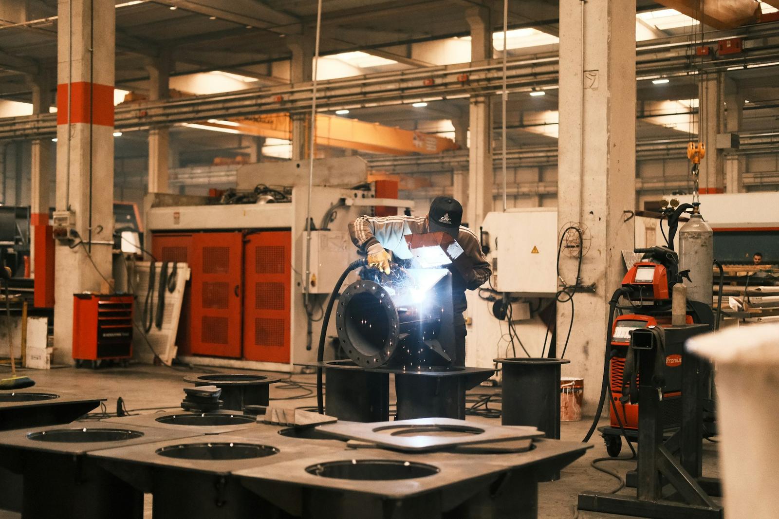 Welder fabricating a custom flanged assembly